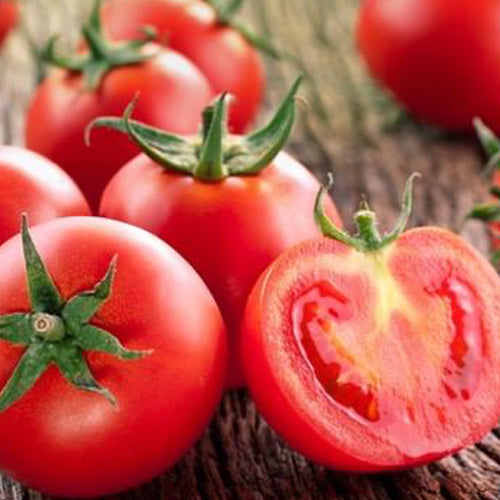 Sub Arctic Plenty Tomato Seeds Close-up of ripe red Sub Arctic Plenty tomatoes, one cut open to show juicy interior, on rustic wooden surface
